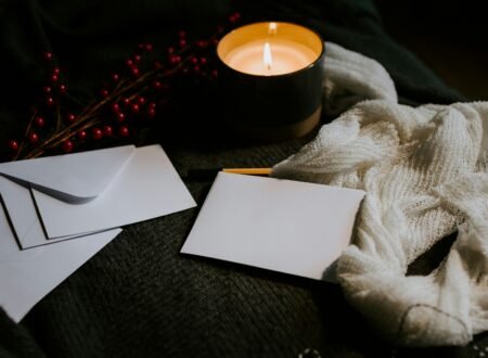 a candle and envelopes on a table